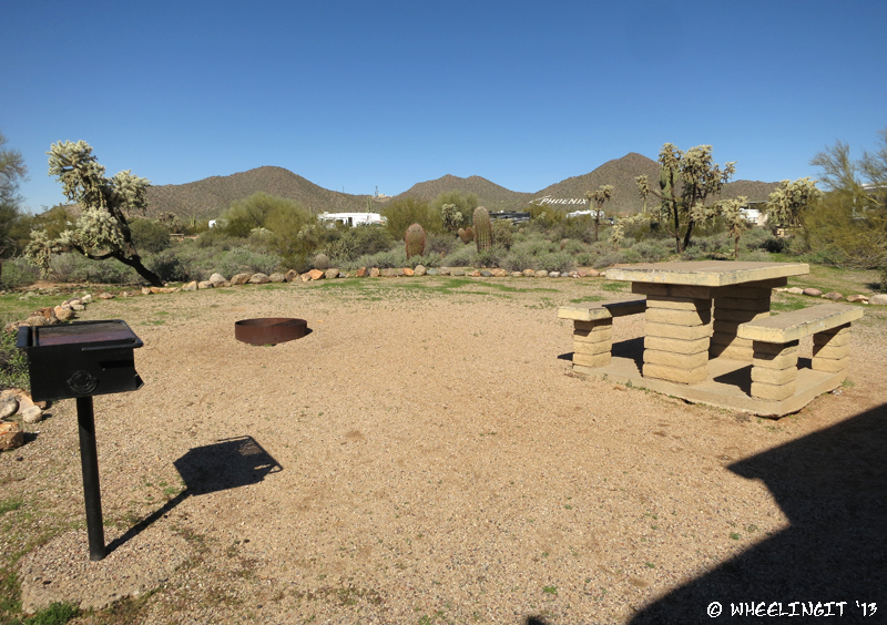 View of "sitting area" with fire-pit, grill and picnic table. This was from site #55