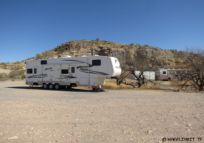View of RV's parked by the hill.