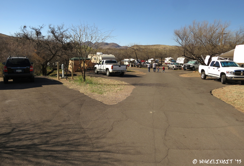 View down middle of East Campground. Car in site #56 on left with #54 behind.