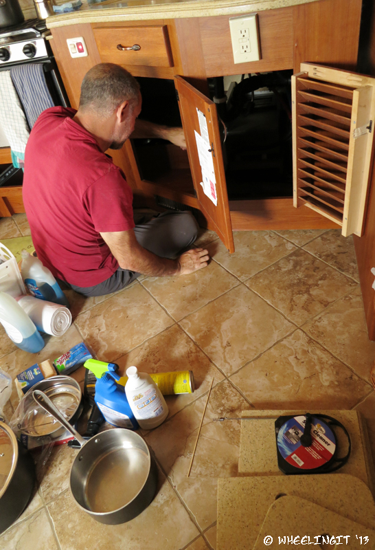 Paul shines a flashlight into the "bowels" of the kitchen