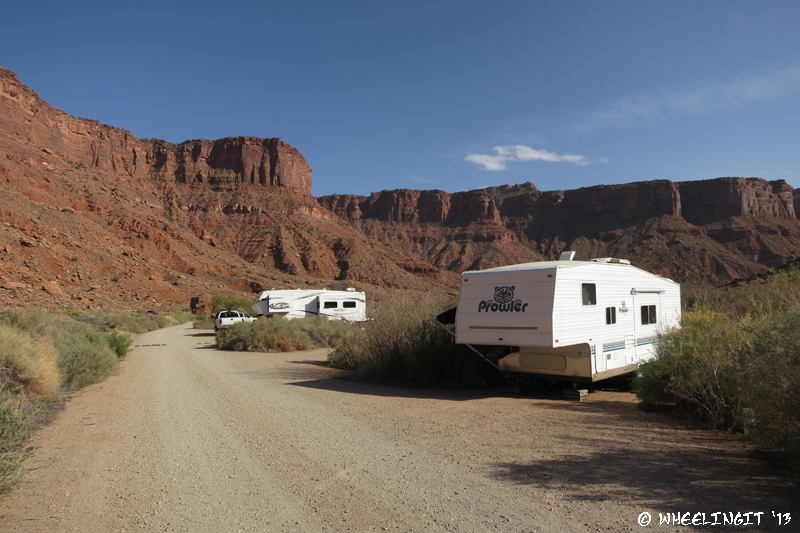 View down back-end of campground. RV in site#15 on right with big rig in #17 behind it.