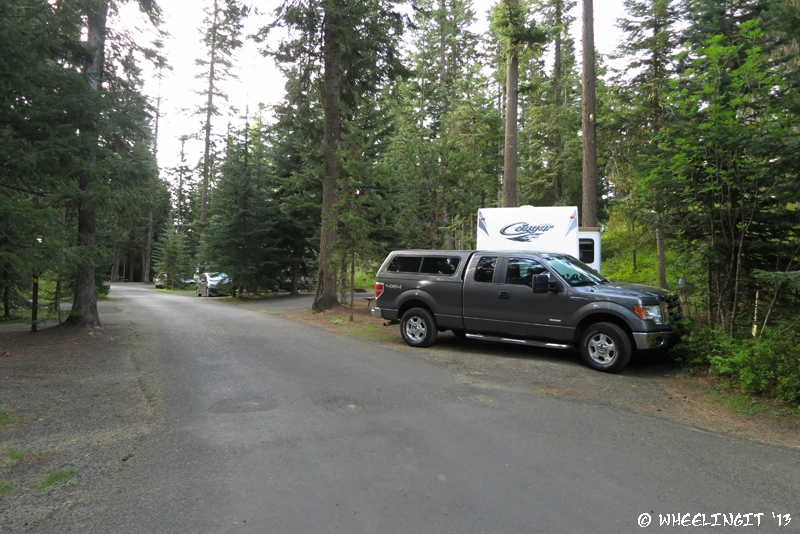 View down back-side of campground. RV in site #B25 with B23, BB21 behind it. These are all full hookup