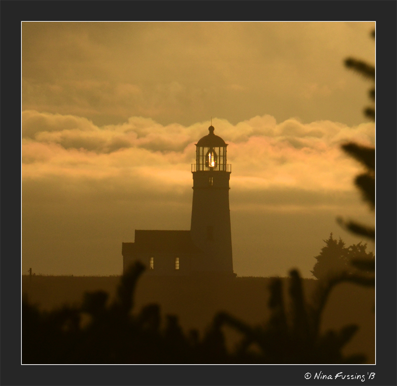 Cape Blanco beams through the light mist
