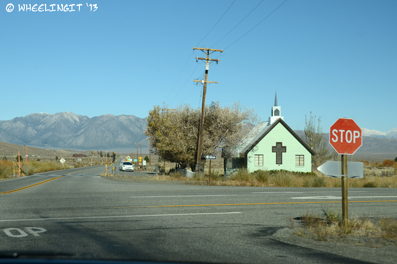 Entrance to Benton Crossing Road showing the "Green Church". First part of road is paved, then turns to wide dirt.