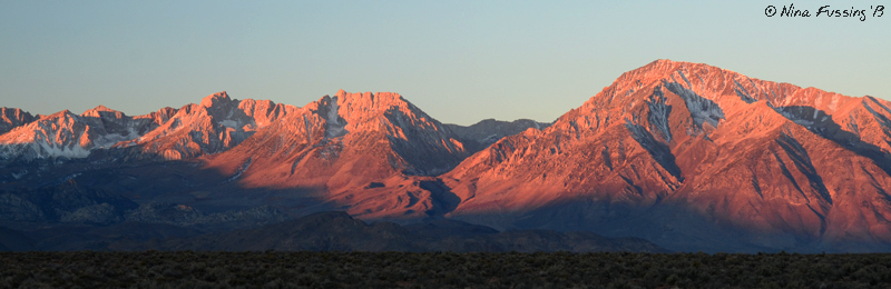 Sunrise paints the mountains red at our boondocking spot