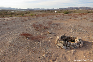 View of an empty site. You can see RVs in the background.