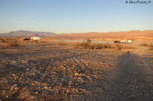 More big rigs parked further along the right-hand dirt road.
