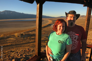 Soft red light illuminates Chris & Cherie against dry Washoe Lake